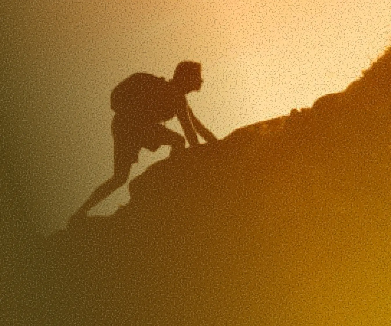 A sillhouette of a person climbing a mountain | the happiness audit – Factory For Good